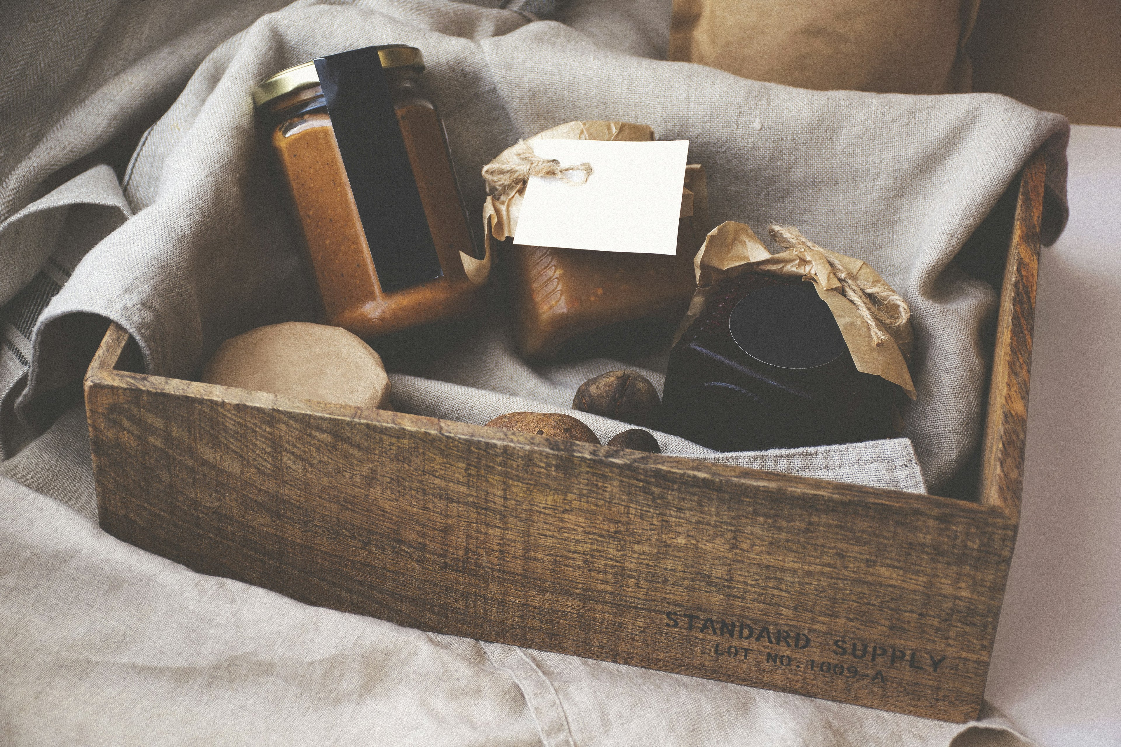 Wooden box with soap and other items on a textured surface